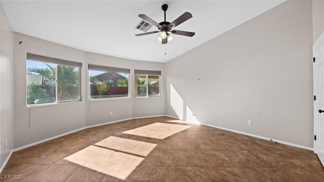 spare room featuring vaulted ceiling, tile patterned floors, and ceiling fan