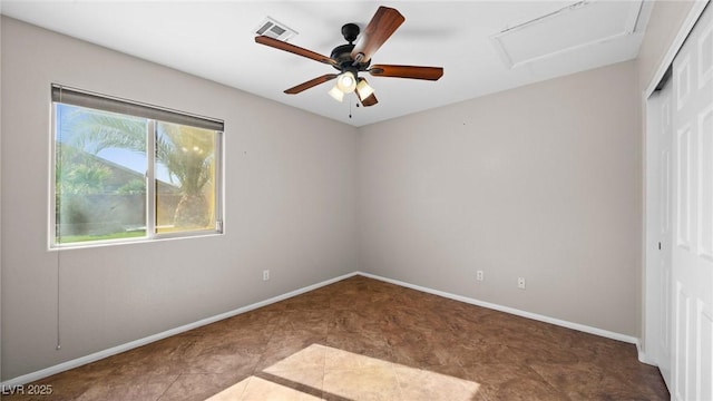 unfurnished bedroom with ceiling fan, tile patterned floors, and a closet