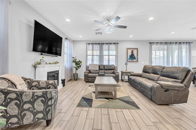 living room featuring a healthy amount of sunlight and ceiling fan