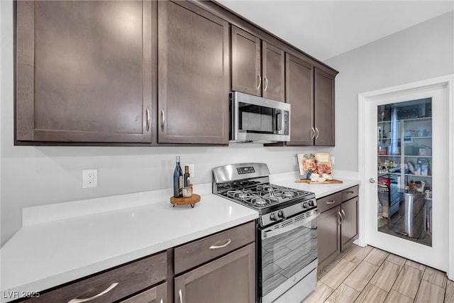 kitchen with appliances with stainless steel finishes and dark brown cabinets