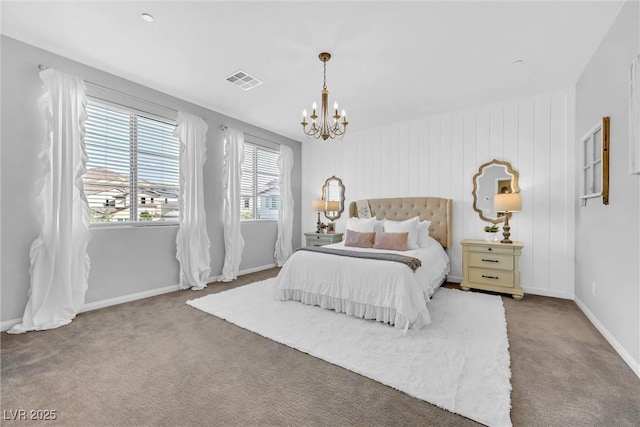 carpeted bedroom featuring a notable chandelier