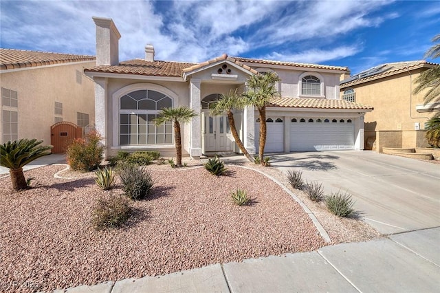 mediterranean / spanish house with a garage