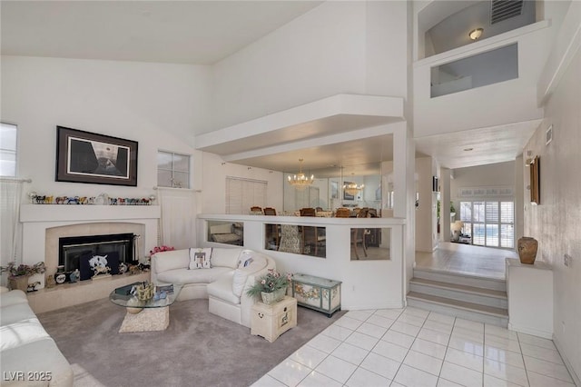 living room featuring light tile patterned floors, high vaulted ceiling, and a chandelier