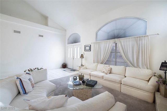 living room with high vaulted ceiling