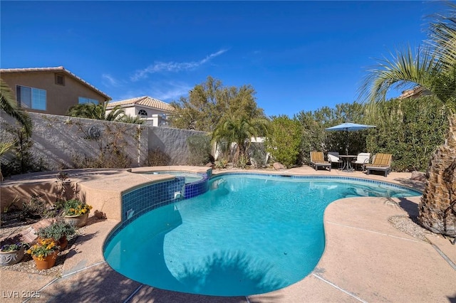 view of swimming pool with an in ground hot tub and a patio