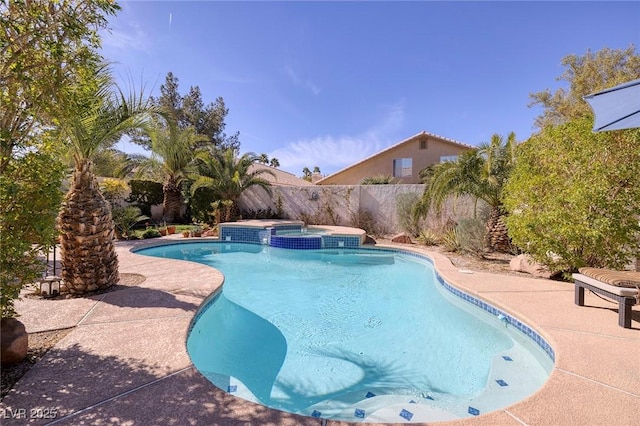 view of pool with an in ground hot tub and a patio