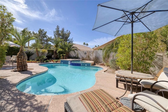 view of swimming pool with an in ground hot tub and a patio area