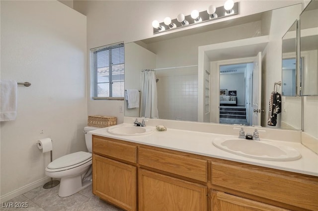 bathroom featuring tile patterned flooring, vanity, curtained shower, and toilet