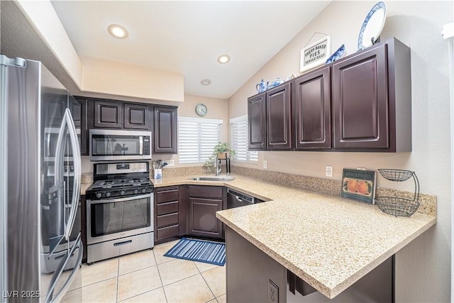 kitchen with sink, light tile patterned floors, stainless steel appliances, dark brown cabinetry, and kitchen peninsula