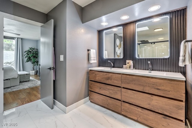 bathroom with vanity, ceiling fan, and walk in shower