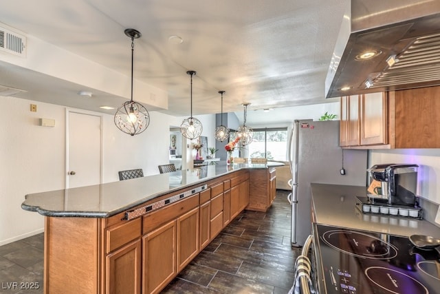 kitchen featuring pendant lighting, stove, a kitchen breakfast bar, a center island, and extractor fan