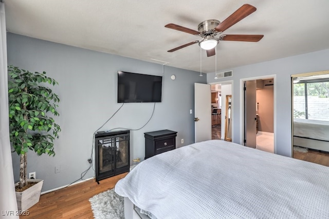 bedroom with hardwood / wood-style flooring and ceiling fan