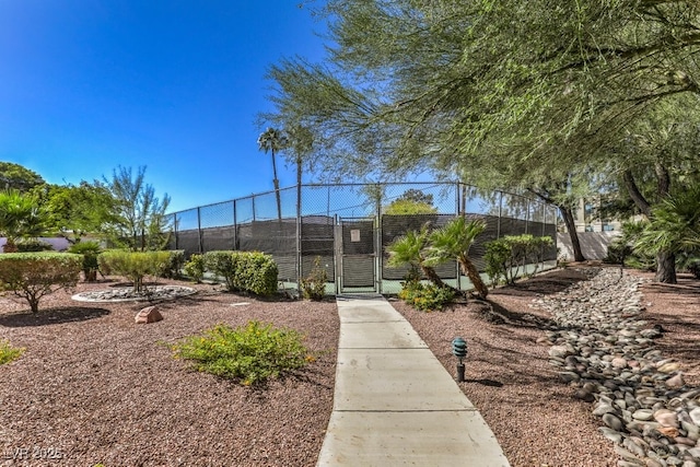 view of community featuring tennis court