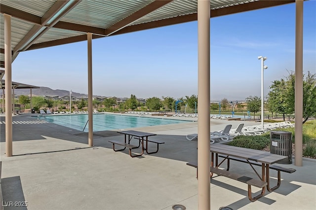 view of swimming pool featuring a mountain view and a patio area