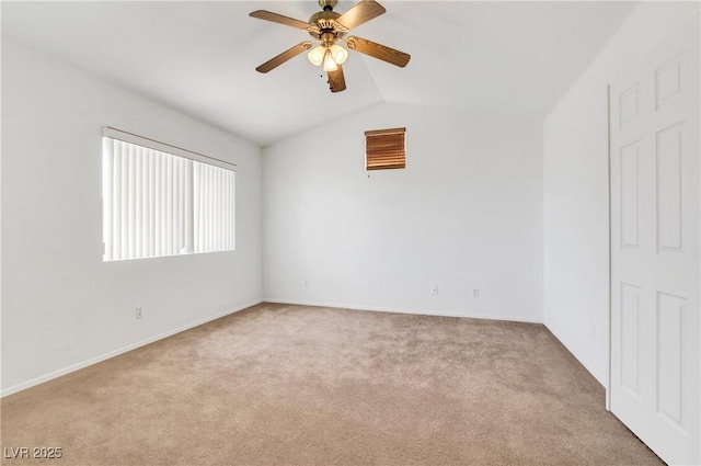 carpeted spare room with vaulted ceiling and ceiling fan