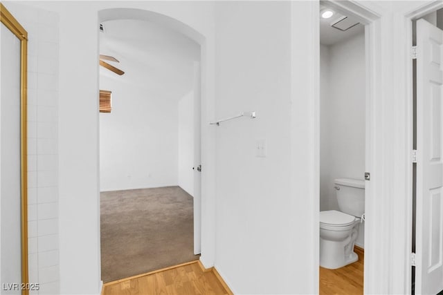 bathroom with hardwood / wood-style flooring, ceiling fan, and toilet