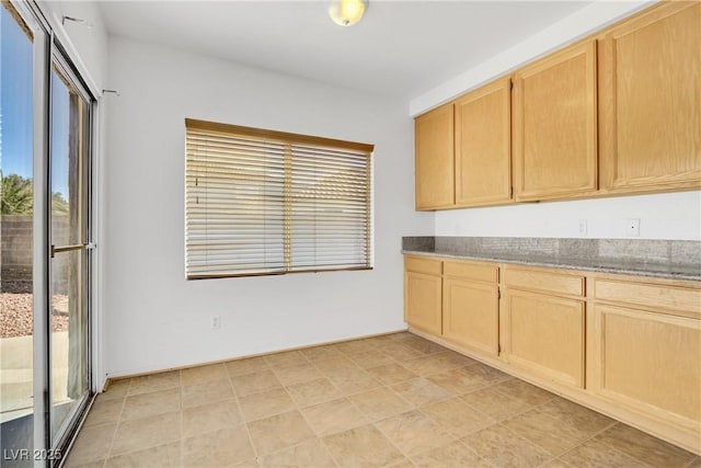 kitchen with a healthy amount of sunlight and light brown cabinets