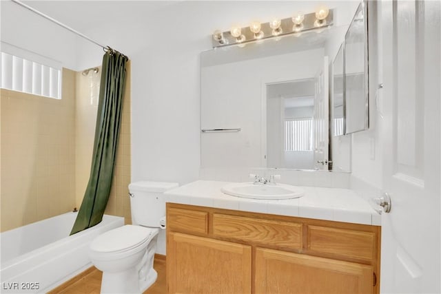 full bathroom featuring vanity, plenty of natural light, shower / tub combo with curtain, and toilet