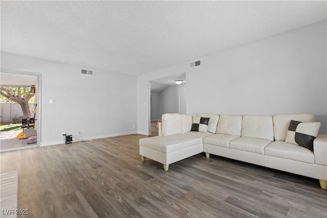 living room with dark hardwood / wood-style floors and a textured ceiling