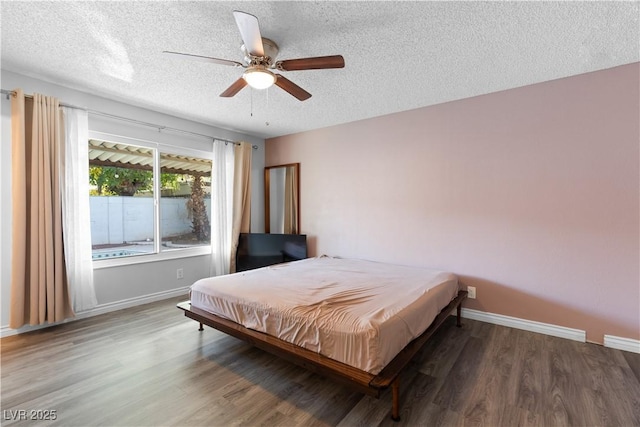 bedroom featuring hardwood / wood-style flooring, ceiling fan, and a textured ceiling