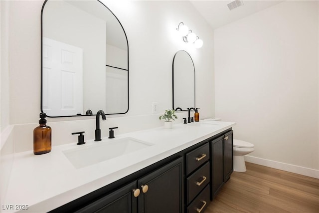 bathroom featuring hardwood / wood-style flooring, vanity, and toilet