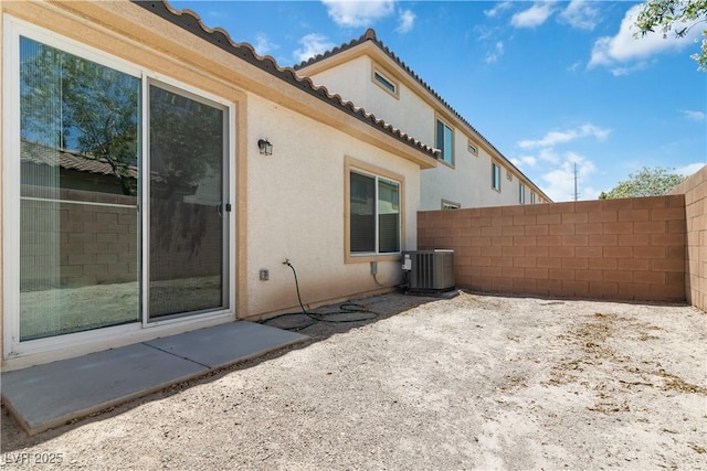 view of side of property featuring central AC and a patio area