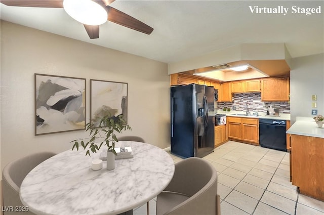 dining area with visible vents, a tray ceiling, a ceiling fan, and light tile patterned flooring