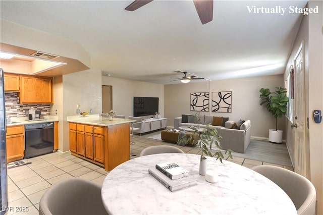 dining space featuring light tile patterned flooring, baseboards, a ceiling fan, and visible vents