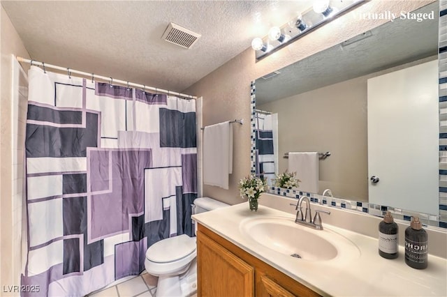 bathroom featuring a textured ceiling, vanity, tile patterned flooring, visible vents, and toilet