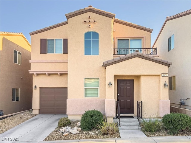 view of front of home with an attached garage, concrete driveway, and stucco siding