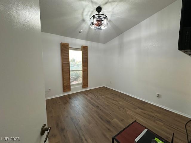 empty room featuring dark wood-type flooring