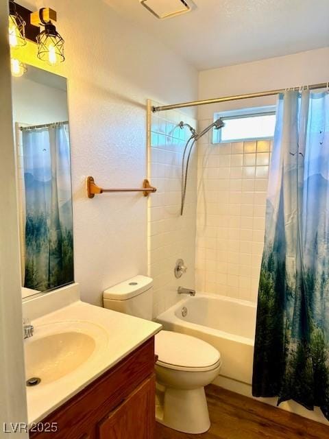 full bathroom with vanity, hardwood / wood-style floors, shower / tub combo, and toilet