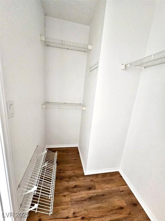 spacious closet featuring hardwood / wood-style floors