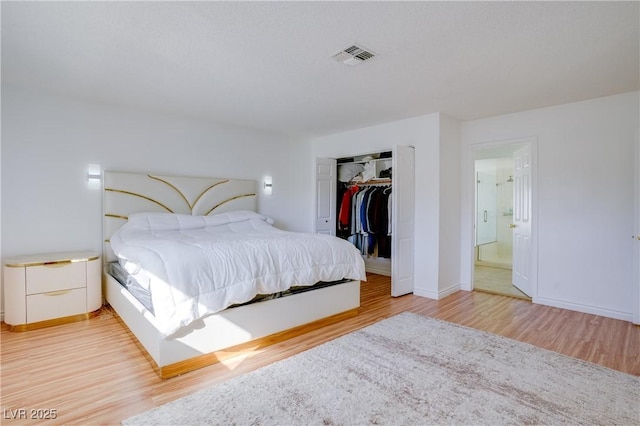 bedroom with hardwood / wood-style flooring and a closet