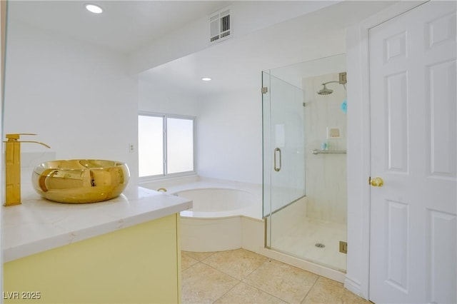 bathroom featuring tile patterned floors, shower with separate bathtub, and sink