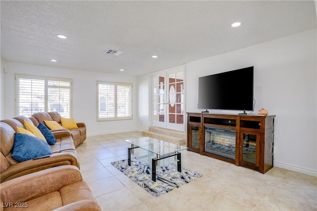 living room with light tile patterned floors and a textured ceiling