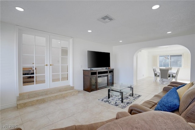 tiled living room with a textured ceiling