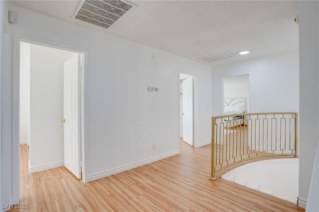 unfurnished room with light hardwood / wood-style floors