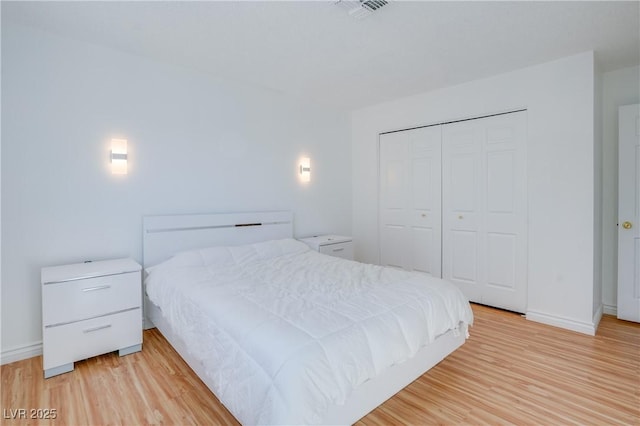 bedroom with a closet and light wood-type flooring