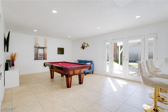 playroom featuring light tile patterned flooring, pool table, a textured ceiling, and french doors