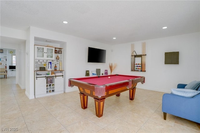 rec room with light tile patterned flooring, pool table, and a textured ceiling