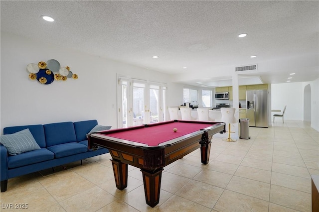 playroom with light tile patterned floors, billiards, french doors, and a textured ceiling