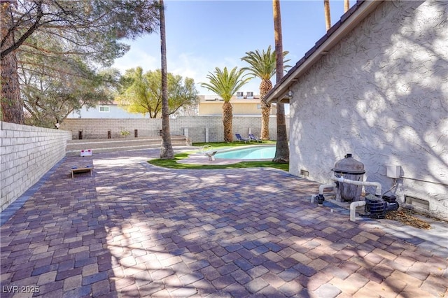 view of patio with a fenced in pool