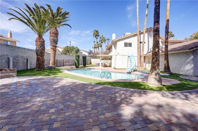 view of pool featuring a patio and a water slide