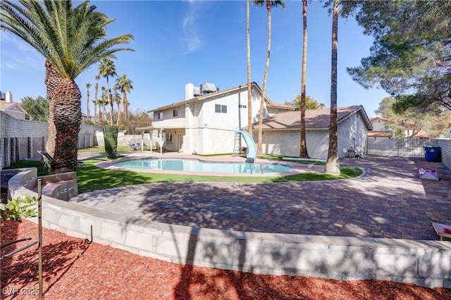 exterior space featuring a fenced in pool and a patio area