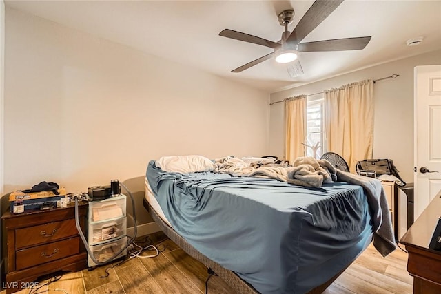 bedroom featuring a ceiling fan and wood finished floors