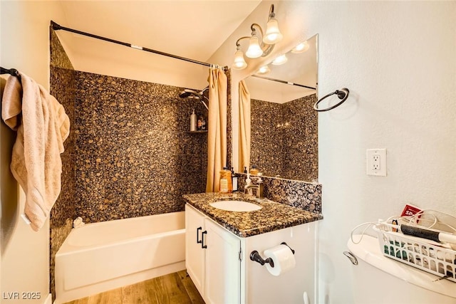 bathroom featuring vanity, wood finished floors, toilet, and shower / bathtub combination with curtain