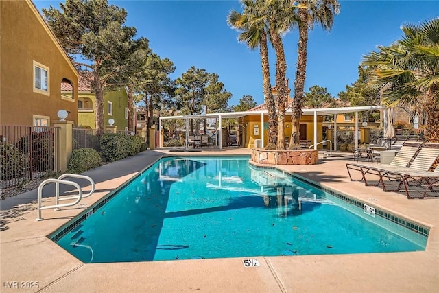 pool with a patio and fence