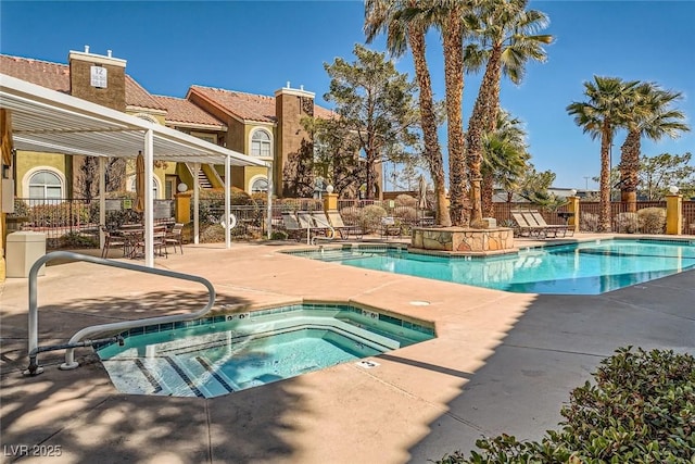 pool featuring a patio, fence, and a hot tub