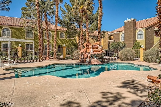 view of swimming pool with a fenced in pool, a patio, and fence